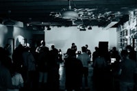 a group of people standing in a dark room